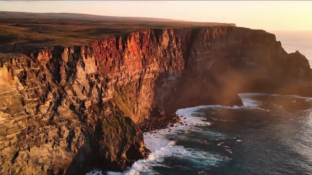 Majestic coastal cliffs carved by millennia of ocean waves, showcasing dramatic sheer drops into turquoise waters under a vast, open sky. Wide aerial view capturing the grandeur and scale of the?