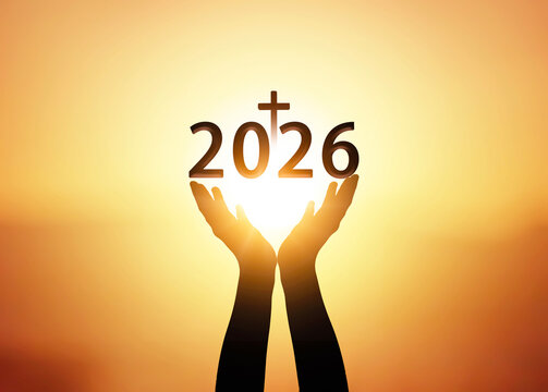 Silhouette of hands holding new year 2026 on sunset background.