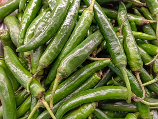 Close-up Pile of Long Green Chili Peppers Food Texture Background