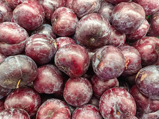 Close-up Pile of Fresh Dark Red and Purple Plums Fruit Texture