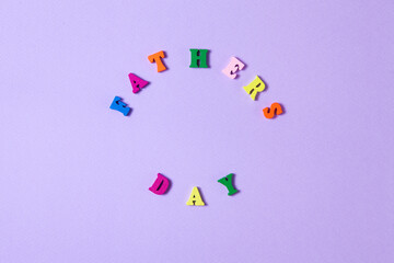 Child's toy letters spelling Fathers Day on purple background. Concept photo. Flat lay design.