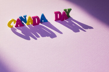 Canada Day wooden letters in the sun. Beautiful greeting card. Close-up. National holiday concept. Congratulations for family, relatives, friends and colleagues.