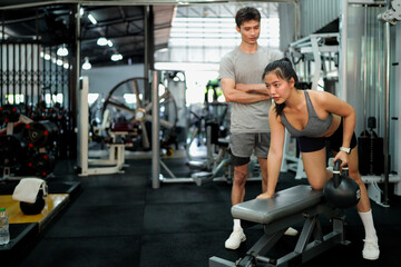 Fototapeta premium gym sport fitness exercise health woman weight training kettlebell trainer coach instructor personal equipment strong healthy fit active workout body man activity