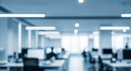 Blurry abstract shot of a modern office space with rows of computers and workstations, ideal for business and technology concepts