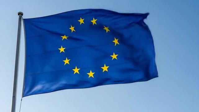 European Union flag waving in the wind against a clear blue sky during daytime - Powered by Adobe