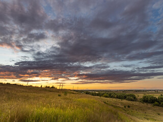 Field of grass with a beautiful sunset in the background
