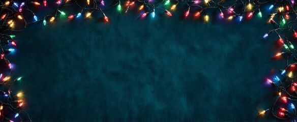 Christmas String Lights Border on Dark Blue Textured Background with Copy Space