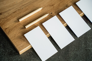 Business card mockup on wooden boards and stone surface
