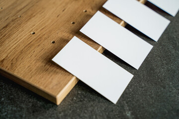 Business card mockup on wooden boards and stone surface
