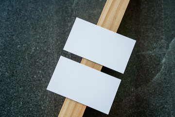 Business card mockup on wooden boards and stone surface

