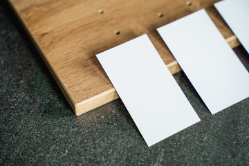 Business card mockup on wooden boards and stone surface
