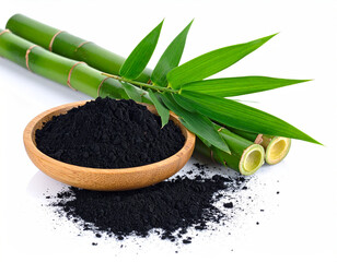 natural composition features several pieces of black charcoal chunks and a wooden bowl filled with fine black charcoal powder. A small wooden scoop holds more powder, and fresh green bamboo leaves add