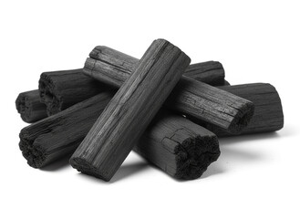 natural composition features several pieces of black charcoal chunks and a wooden bowl filled with fine black charcoal powder. A small wooden scoop holds more powder, and fresh green bamboo leaves add