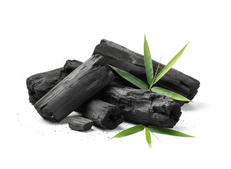 natural composition features several pieces of black charcoal chunks and a wooden bowl filled with fine black charcoal powder. A small wooden scoop holds more powder, and fresh green bamboo leaves add