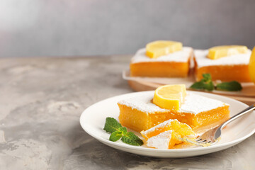 Tasty lemon bars with mint on grey marble table, closeup. Space for text