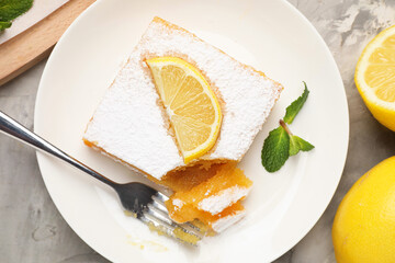 Tasty lemon bar with mint and fresh fruits on grey marble table, flat lay