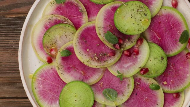 watermelon radish daikon salad on white plate food top rotation