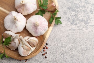 Garlic, peppercorns and parsley on light table, top view. Space for text