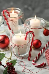 Beautiful Christmas lanterns and festive decor on white marble table, closeup