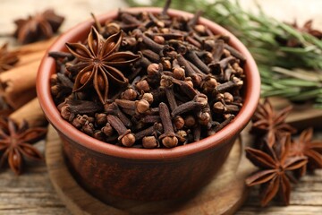 Mulled wine spices. Cloves and anise star in bowl on table, closeup