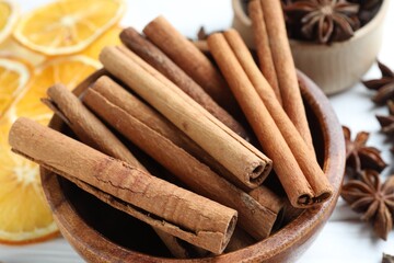 Mulled wine spices. Cinnamon sticks, anise stars and dry orange slices on light table, closeup
