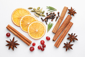 Different spices, cranberries, dry orange slices and fresh rosemary for mulled wine on white table, flat lay