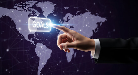 Hand touches a glowing "GOALS" button over a world map with connecting lines, representing global strategy, achievement, and international objective