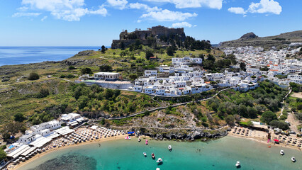 Aerial drone photo of iconic archaeological site of Acropolis of Lindos built uphill featuring...