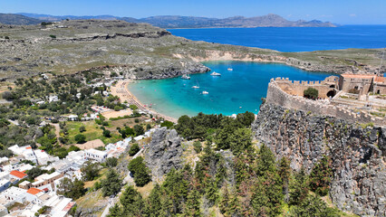 Aerial drone photo of iconic archaeological site of Acropolis of Lindos built uphill featuring...
