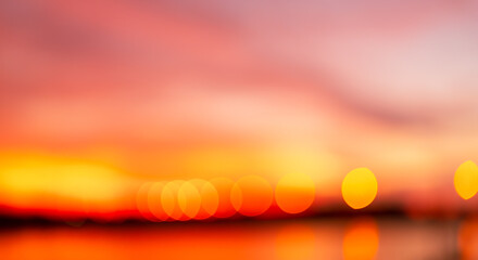 Orange blurred focus sky background,abstract pink orange blurred background with dark stripe on horizon. Blur pastel colored sweet dreamy background. Pink orange bokeh out of focus natural sky 