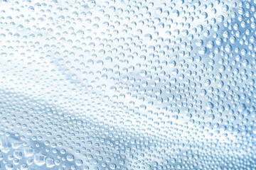 Macro Photo of Water Drop Textured on drinking water bottle for background or wallpaper,Close-up macro shot of water vapor texture on a water bottle,water bubbles in bottle, macro shot.