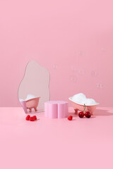 Pink miniature bathtub in pink bathroom with bubble raspberry cherry and pink product stand for packshot