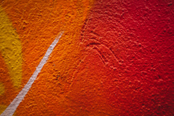 Close-up view of textured wall with vibrant yellow orange and red colors background
