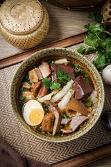 Chinese rolled noodles with crispy pork and egg in black soup,Rolled Rice Noodles in Five-spices Broth , Chinese noodles, thai called kuay jap
