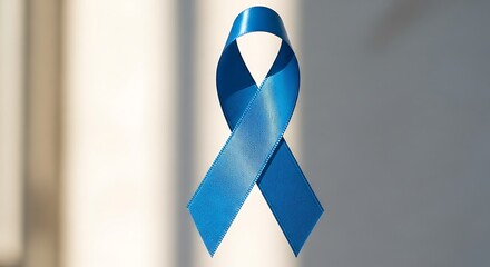 Blue Awareness Ribbon Symbol in Focus on Neutral Background for Support and Health Campaigns