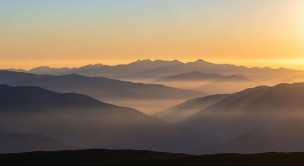 Golden Sunrise Over Misty Mountain Ranges - A Serene Landscape.