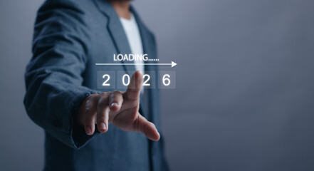 Businessman touching virtual interface with loading 2026 concept. Future planning, business...