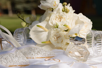 Elegant wedding essentials with delicate flowers and sparkling accessories on a sunny day