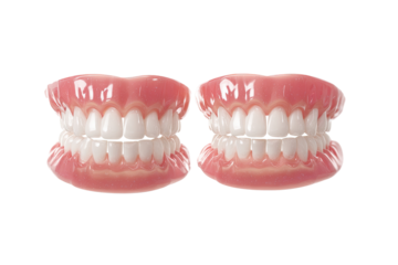 Two identical full dentures, front view, showing rows of white teeth and pink gum tissue