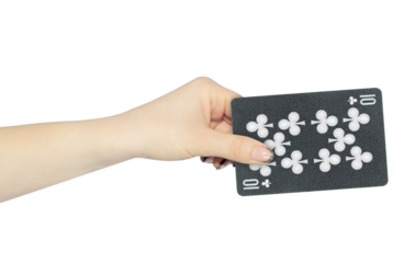 playing card clubs 10 in hand, outstretched hand with black playing card isolated from background