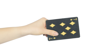 playing card diamonds 7 in hand, outstretched hand with black playing card isolated from background