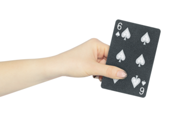 playing card spades 6 in hand, outstretched hand with black playing card isolated from background
