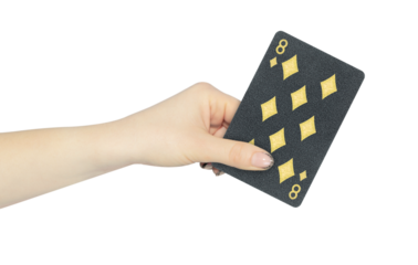 playing card diamonds 8 in hand, outstretched hand with black playing card isolated from background