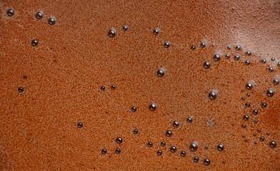 Foamy surface of freshly stirred chocolate drink with tiny bubbles creating a rich textured background ideal for dessert concepts, beverage branding and sweet food advertising designs