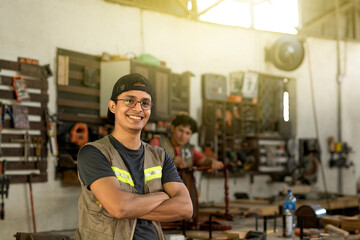 Successful carpenter with arms crossed smiling at the camera