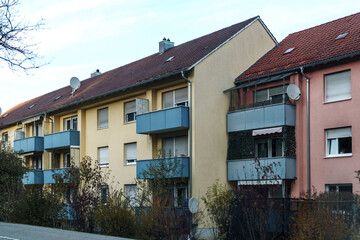Modern residential buildings with colorful facades and balconies in a quiet neighborhood
