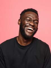 Obraz premium handsome unshaven young darkskinned male laughing out loud at funny meme he found on internet smiling broadly showing his white straight teeth positive human facial expressions and emotions no logos 