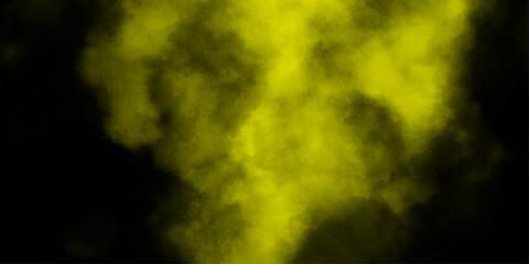 Yellow color powder explosion cloud isolated on black background.  dust smoke . Yellow dust particles explosion background .