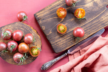 Raw Organic Heirloom Cherry Tomatoes on a cutting board