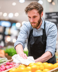 A focused worker cleans fresh produce in a vibrant market, showcasing dedication to quality and customer service.